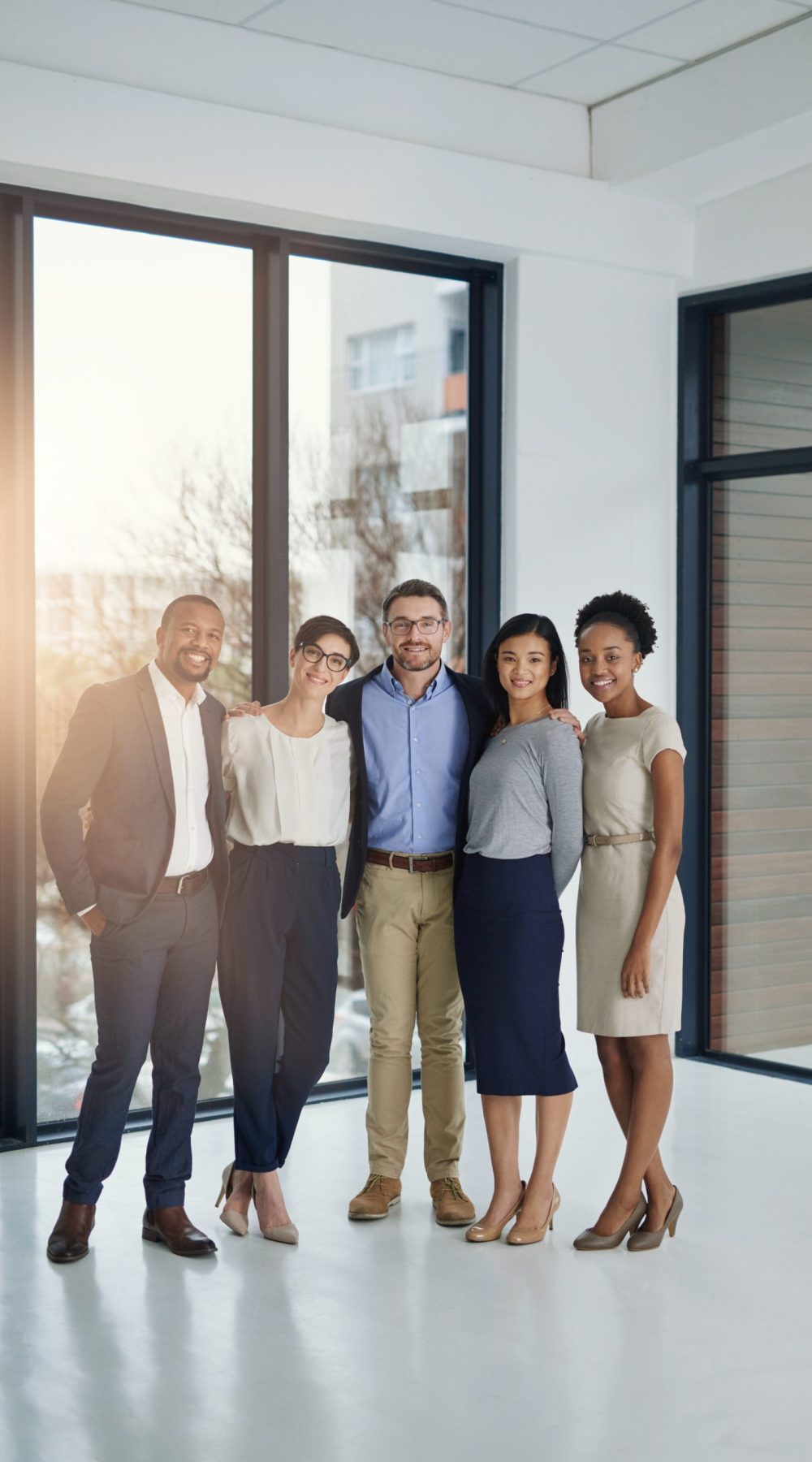 Portrait of a diverse team of professionals standing together in the office.